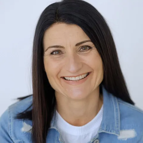 Lydia Hickson smiling, wearing a denim jacket